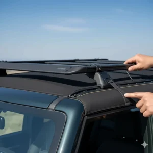Close-up view of the adjustable crossbars and mounting points of the roof rack specifically designed for use with a Bronco soft top.